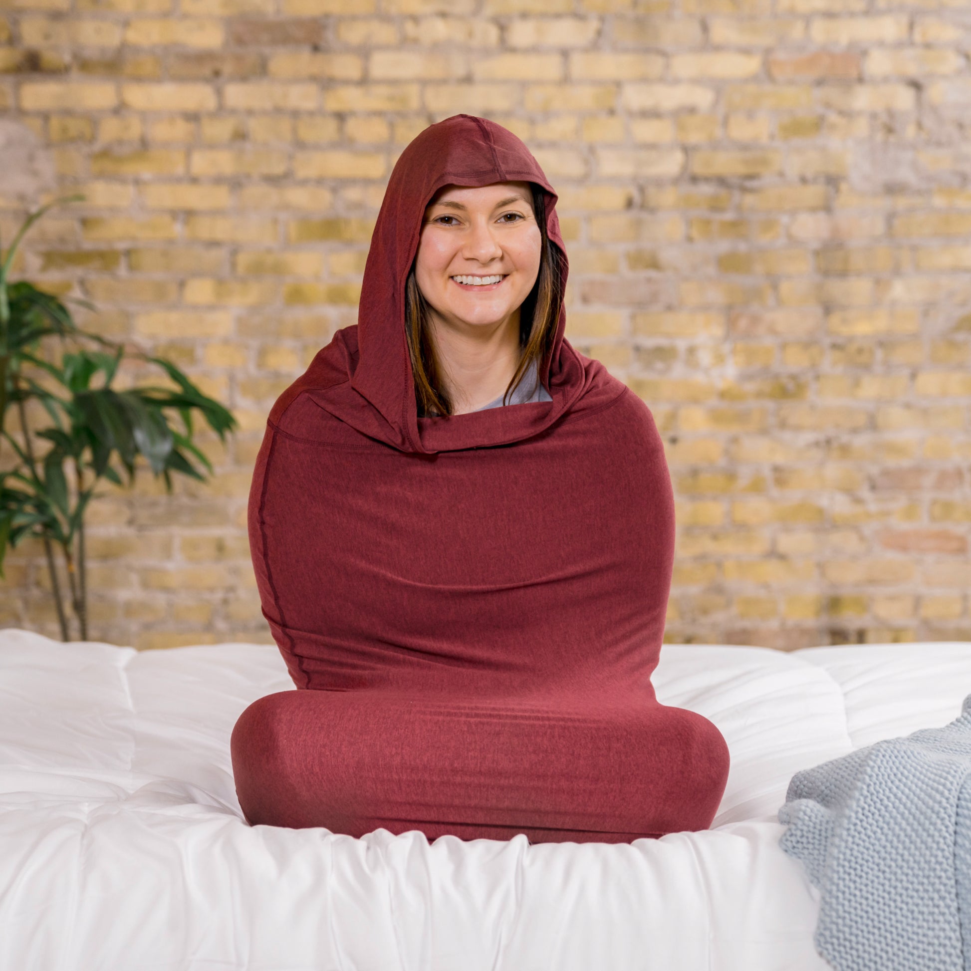 woman on bed in hug sleep pod mini