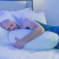 man sleeping in sleep pod holding Pod Pillow™