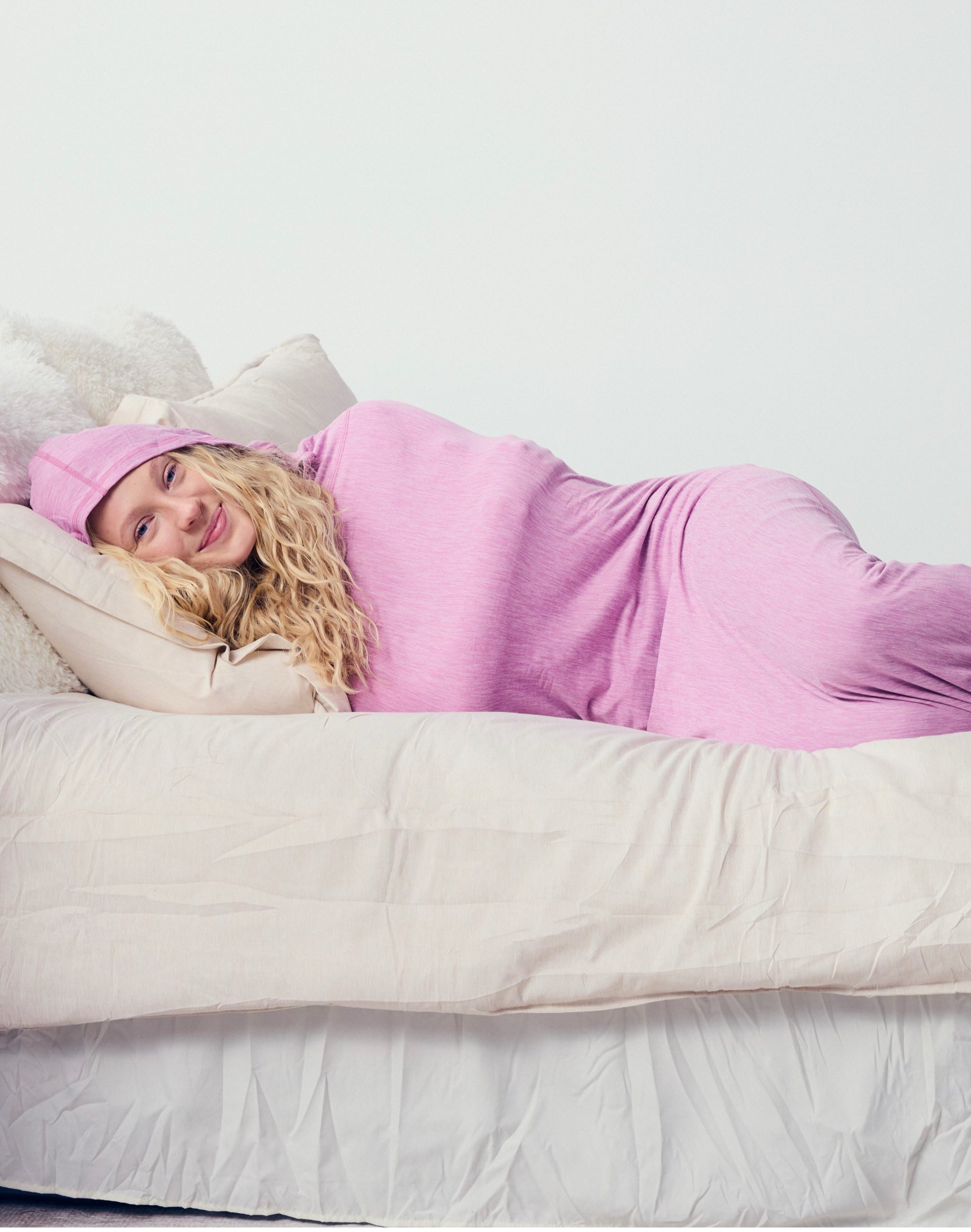 woman in sleep pod laying in bed