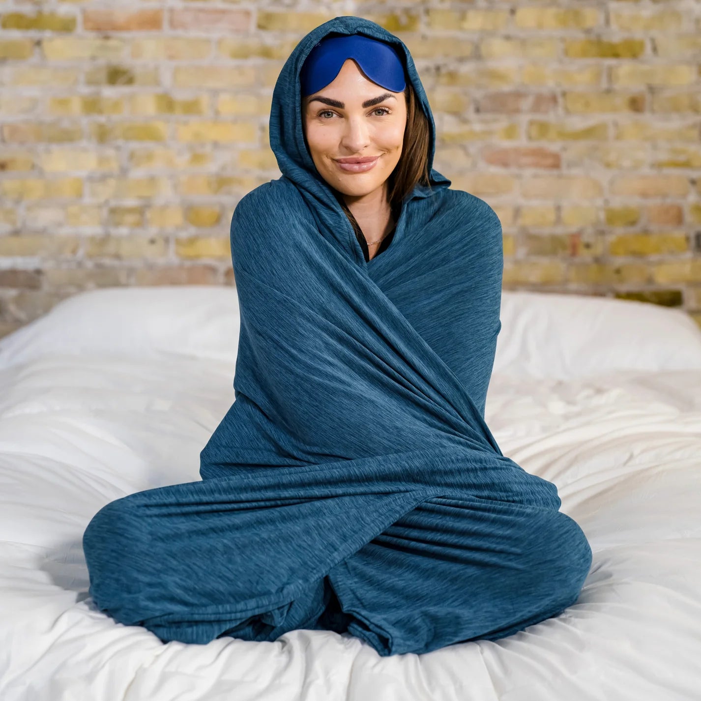 Woman sitting on bed in Hug Wrap