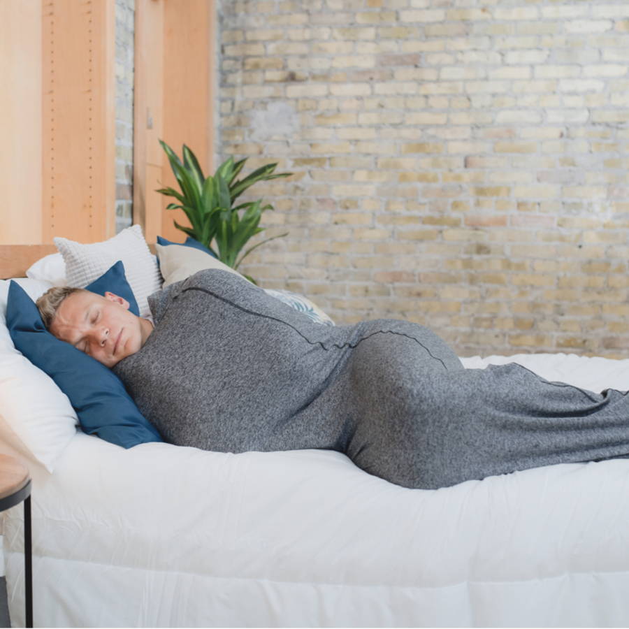 image of man laying in bed with sleep pod  on