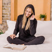 woman wearing hug sleep loungewear in black cream