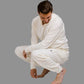 man squatting down wearing hug sleep loungewear in cream cream
