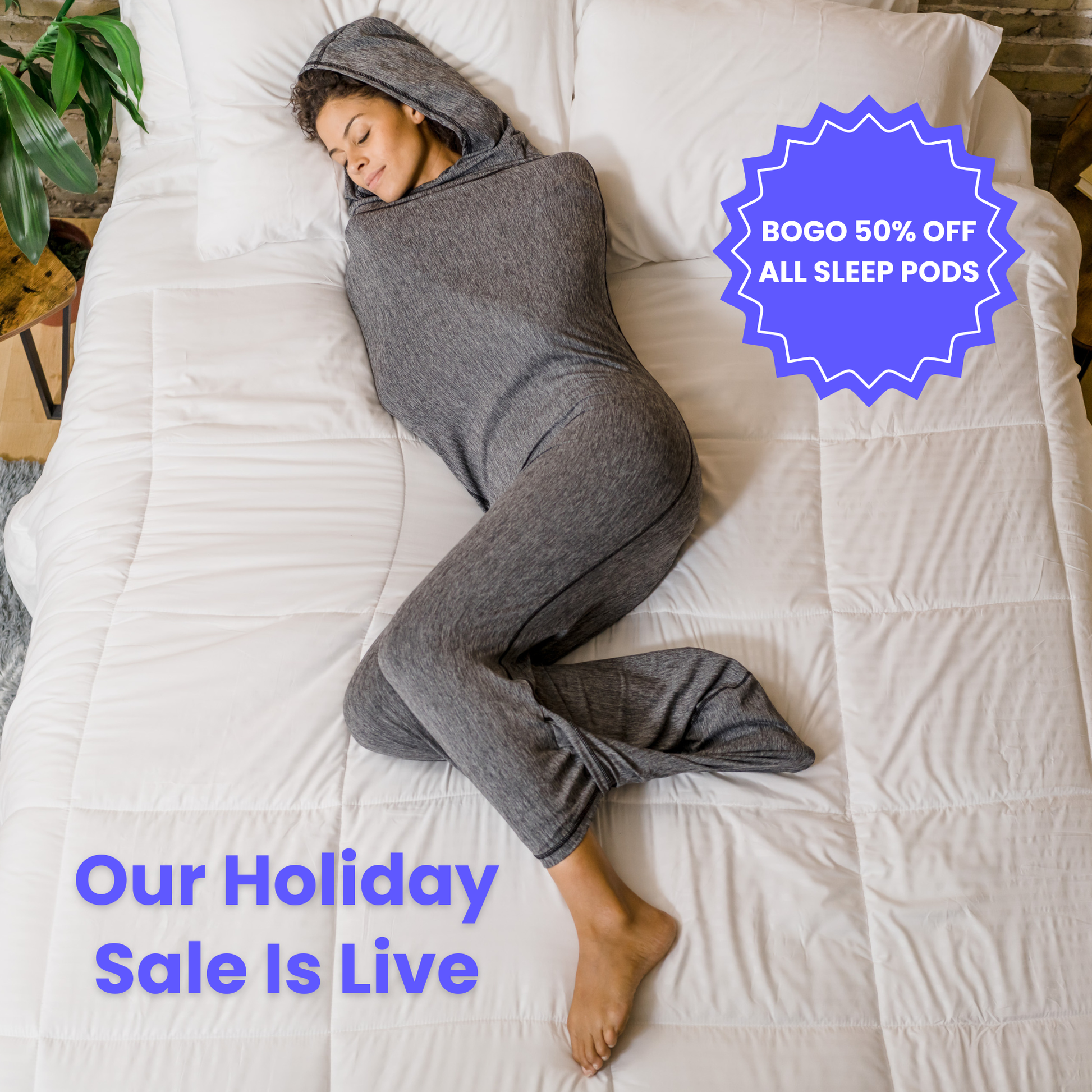 Woman in graphite color sleep pod in bed -  badge that says "BOGO 50% OFF ALL SLEEP PODS" and "OUR HOLIDAY SALE IS LIVE"