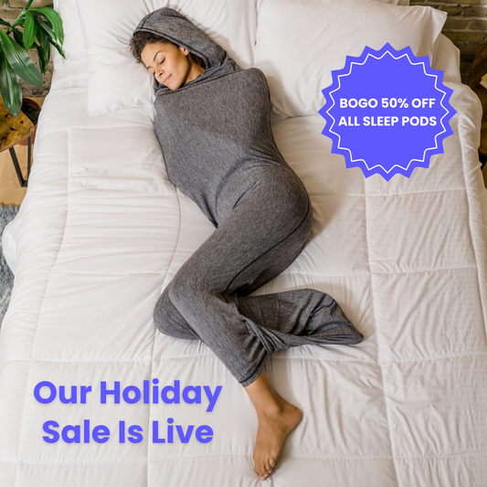 Woman in graphite color sleep pod in bed -  badge that says "BOGO 50% OFF ALL SLEEP PODS" and "OUR HOLIDAY SALE IS LIVE"