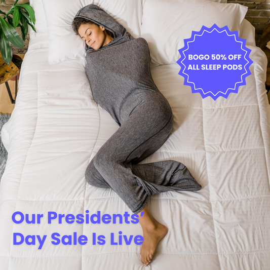 Woman in graphite color sleep pod in bed -  badge that says "BOGO 50% OFF ALL SLEEP PODS" and "OUR PRESIDENTS' DAY SALE IS LIVE"