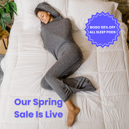 Woman in graphite color sleep pod in bed -  badge that says "BOGO 50% OFF ALL SLEEP PODS" and "OUR SPRING SALE IS LIVE"