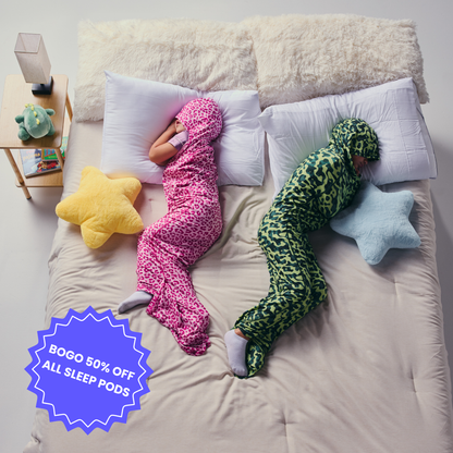 Kid in pink sleep pod and another kid in camo sleep pod laying in bed -  badge that says "BOGO 50% OFF ALL SLEEP PODS" 