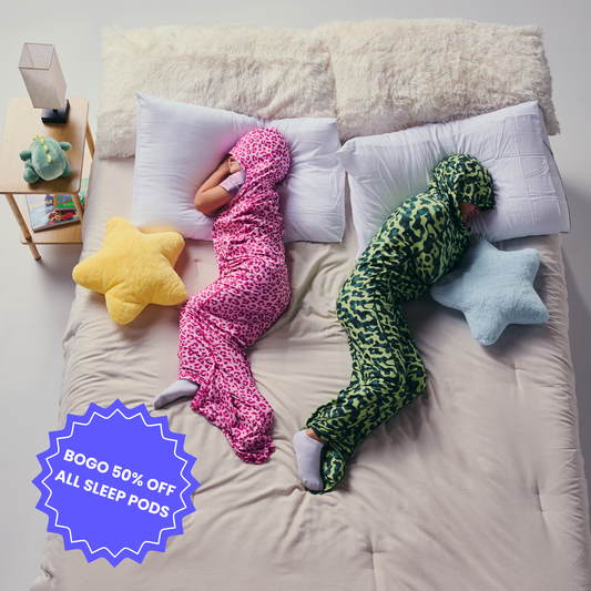 Kid in pink sleep pod and another kid in camo sleep pod laying in bed -  badge that says "BOGO 50% OFF ALL SLEEP PODS" 