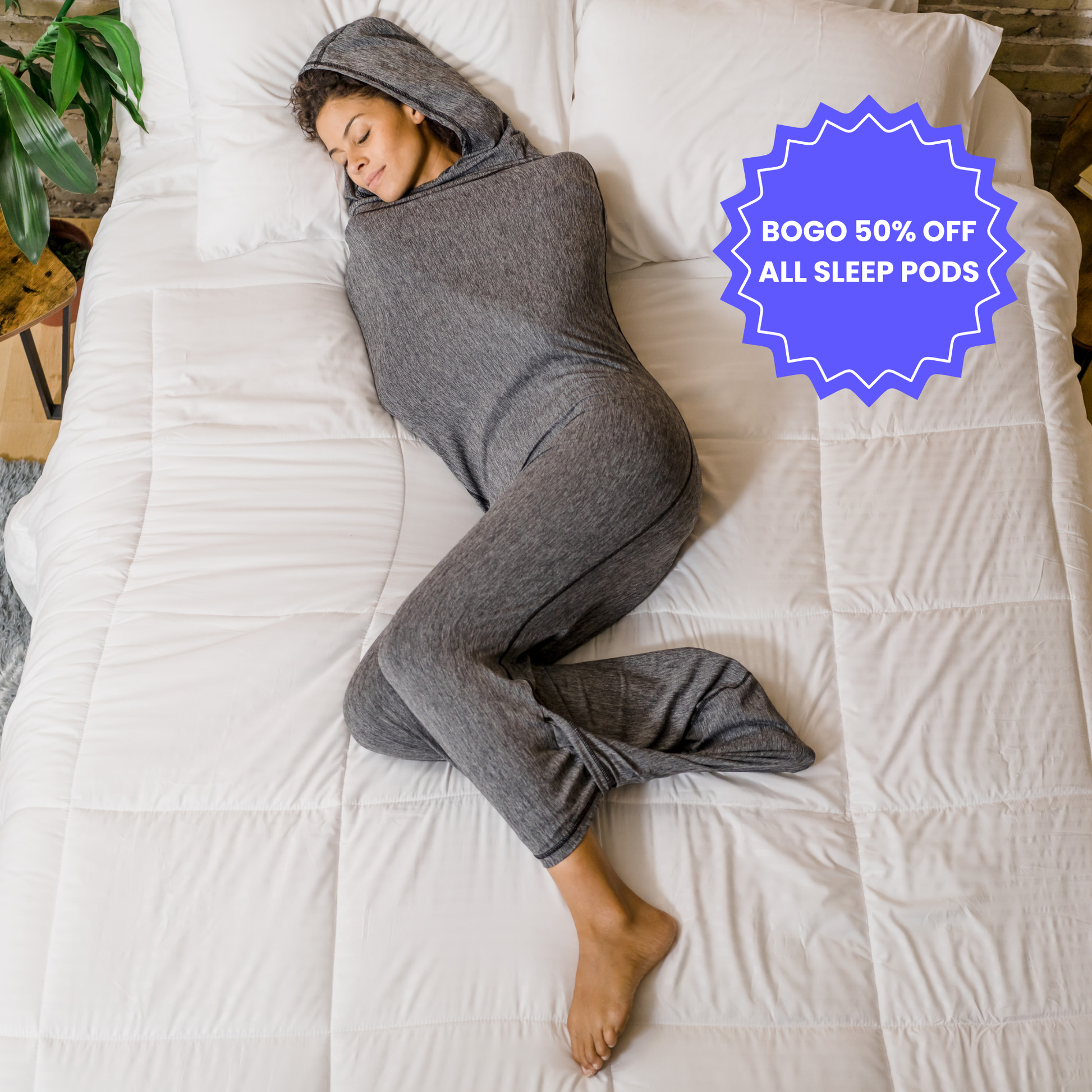 Woman in graphite color sleep pod in bed -  badge that says "BOGO 50% OFF ALL SLEEP PODS" 