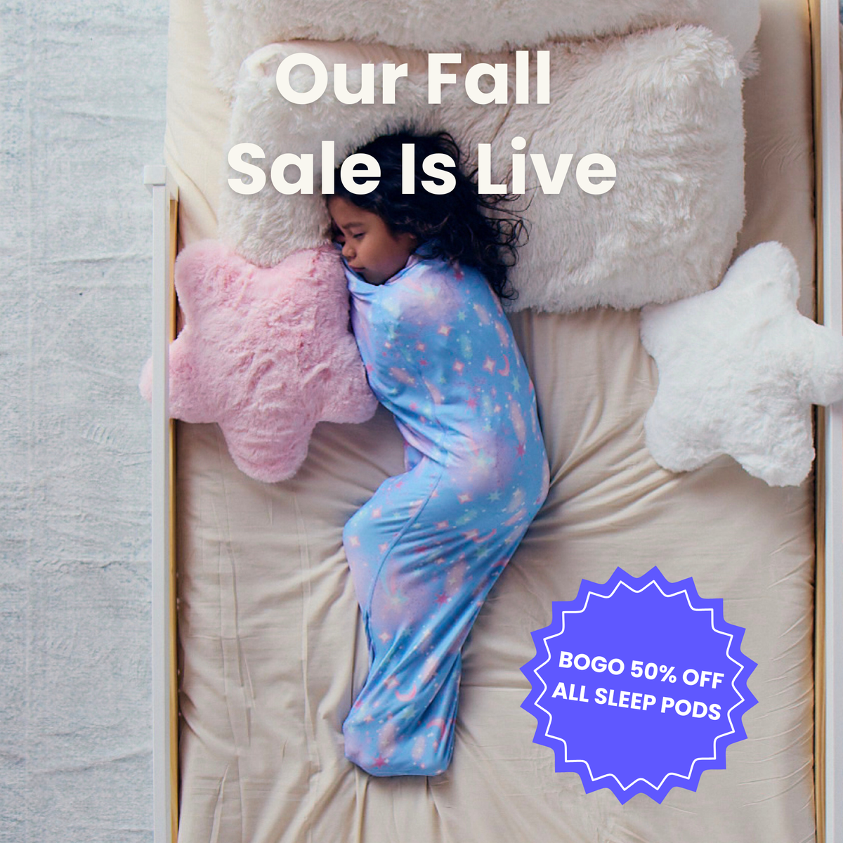 Kid in blue starry sleep pod laying in bed -  badge that says "BOGO 50% OFF ALL SLEEP PODS" and "OUR FALL SALE IS LIVE"