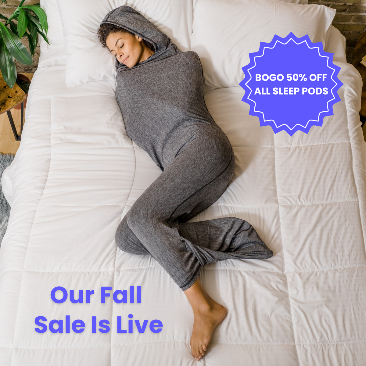 Woman in graphite color sleep pod in bed -  badge that says "BOGO 50% OFF ALL SLEEP PODS" and "OUR FALL SALE IS LIVE"