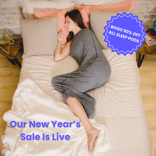 Graphite#woman laying in bed with sleep pod asleep - badge that says "BOGO 50% OFF ALL SLEEP PODS" and "OUR NEW YEAR'S SALE IS LIVE"
