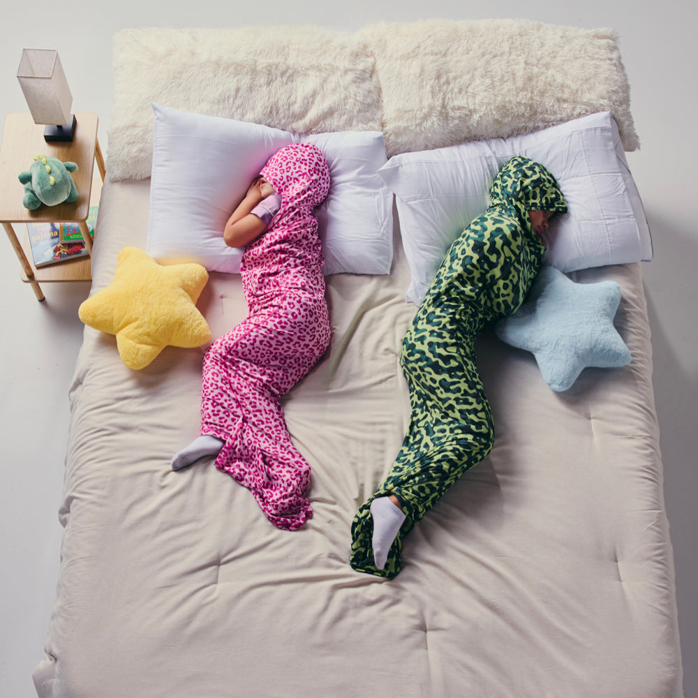 Two kids in sleep pod on bed