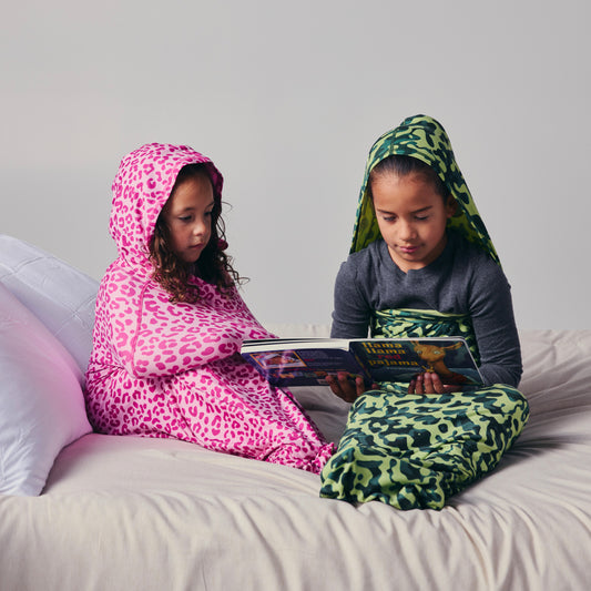 kids-in-sleep-pod-on-bed-reading-a-book