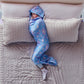Child sleeping on a bed in a blue star-patterned hooded Sleep Pod.
