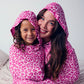 woman and child in leopard pink sleep pods smiling looking at camera