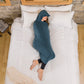 woman in sleep pod mini laying in bed