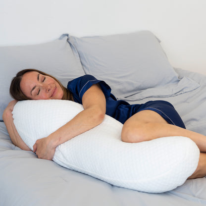 woman laying down hugging body pillow