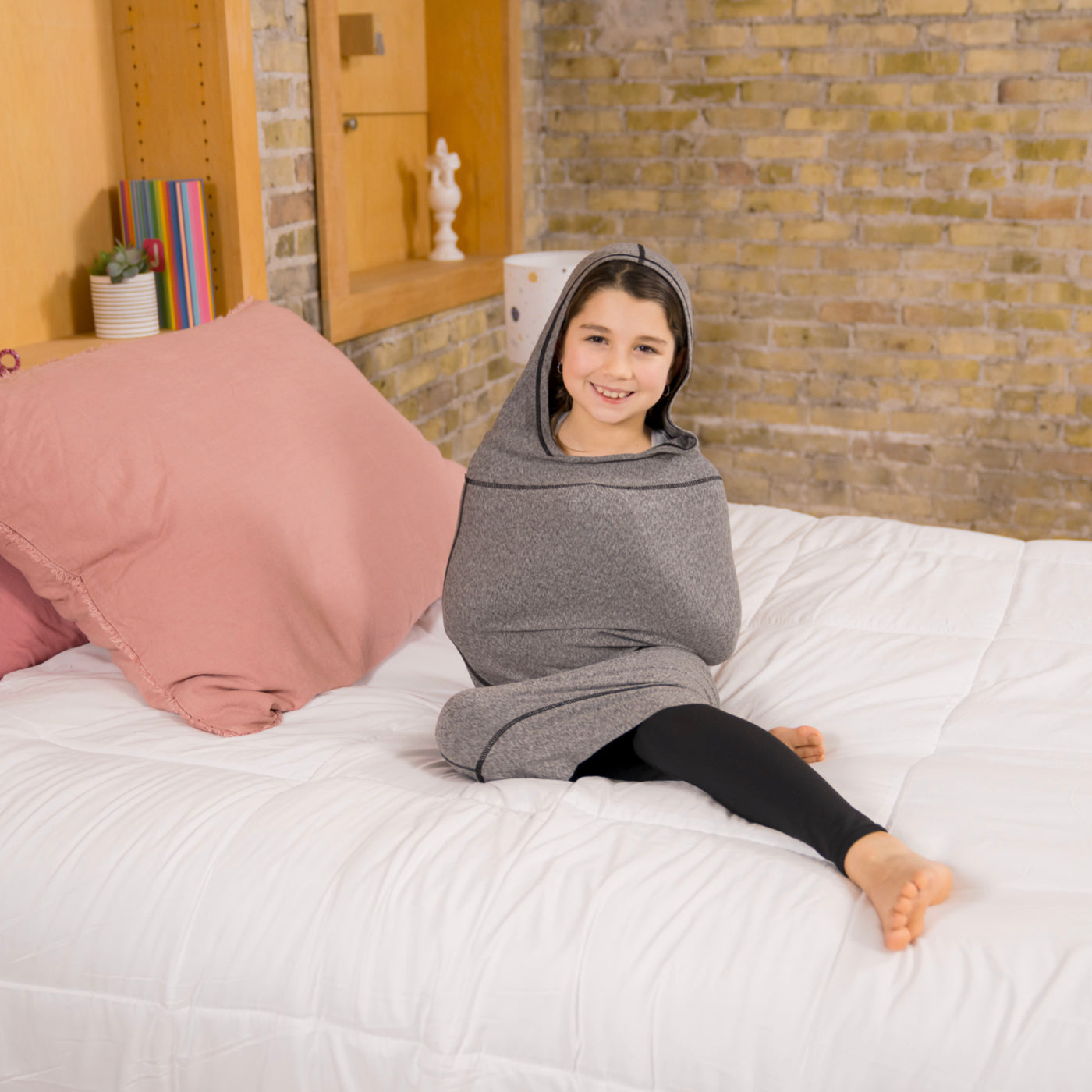 young girl on bed in grey sleep pod mini