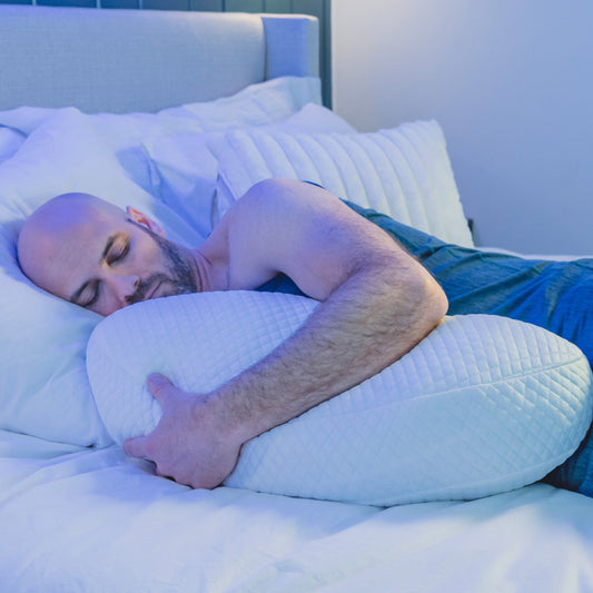 man-sleeping-in-sleep-pod-holding-pod-pillow™