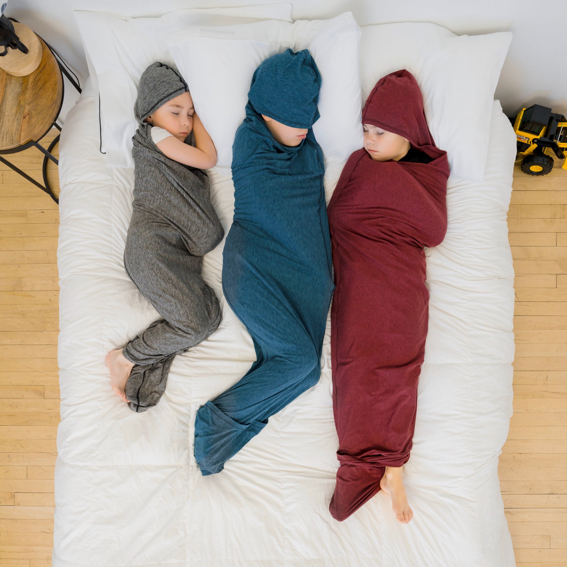 three kids sleeping in sleep pods