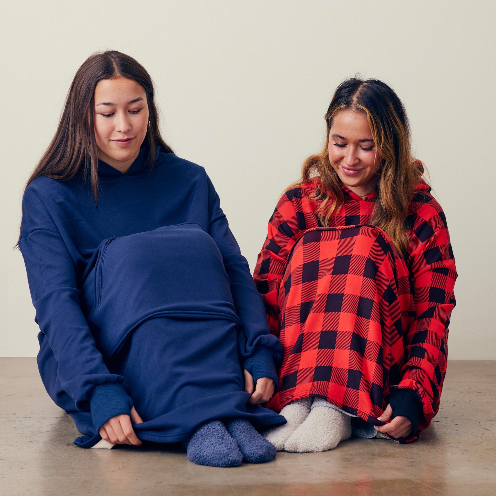 two women wearing hug hoodies