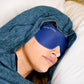 woman in bed sleeping in a sleep pod hood with hug sleep mask on