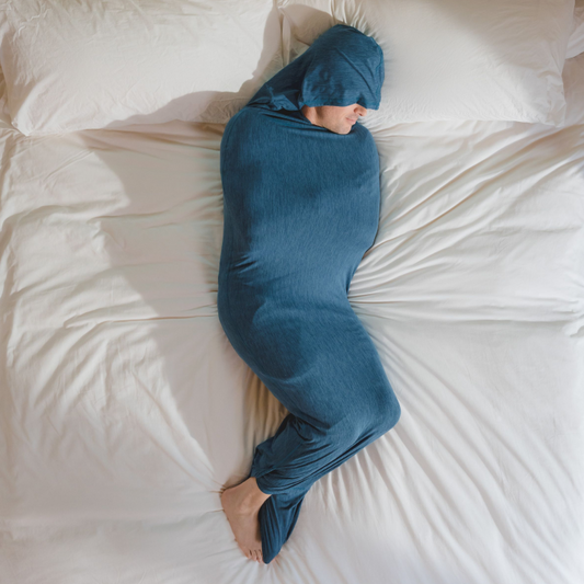 man in Sleep Pod Hood in bed laying down