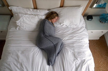 Woman in Sleep Pod sleeping on bed