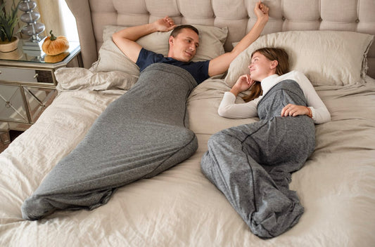 man-in-woman-in-sleep-pods-laying-in-bed-awake-looking-at-each-other