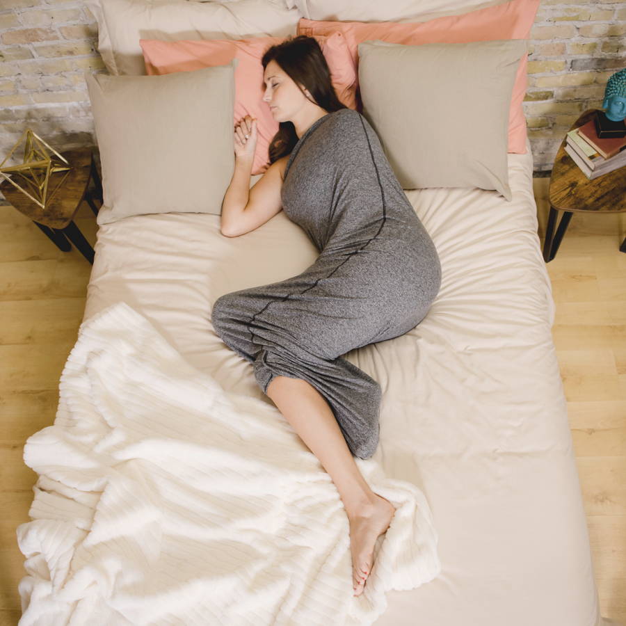 woman laying in bed with sleep pod asleep